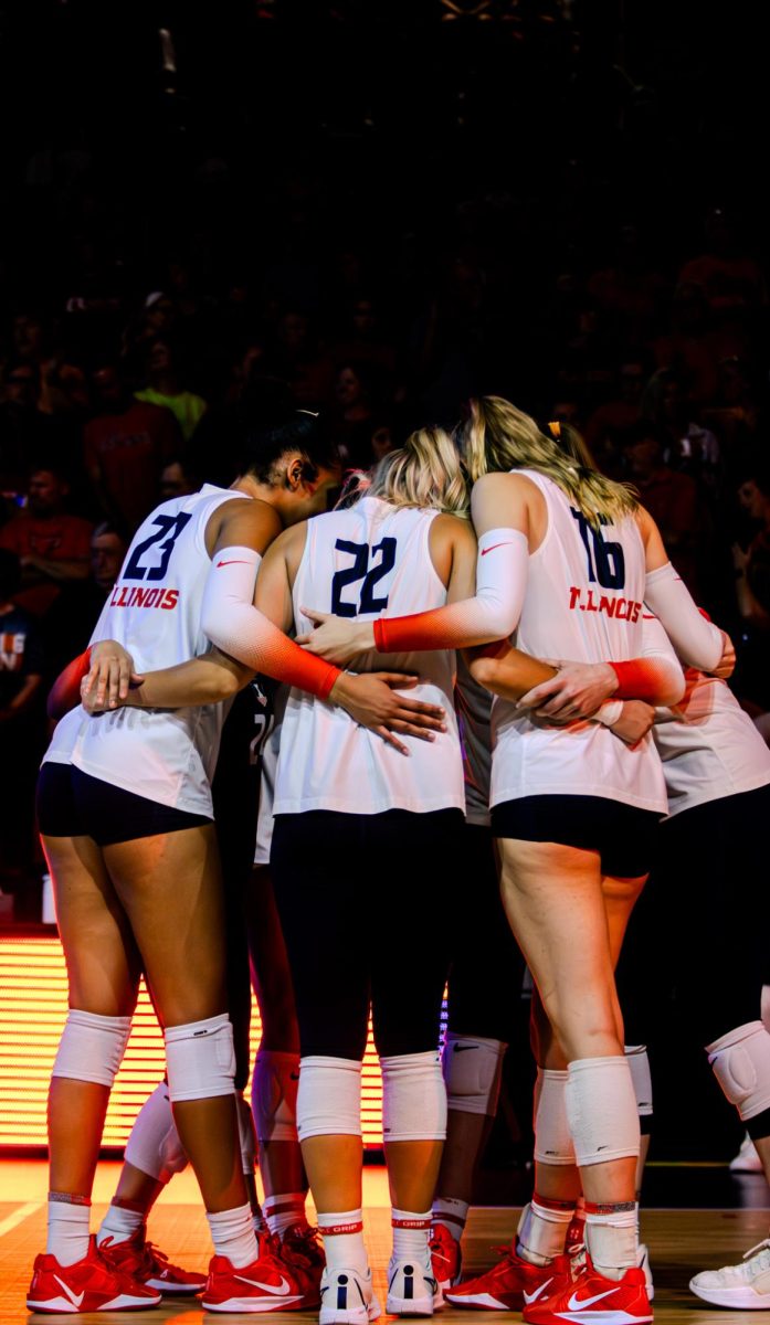 Illinois volleyball huddles before its Oct. 3 matchup against Nebraska in Huff Hall.