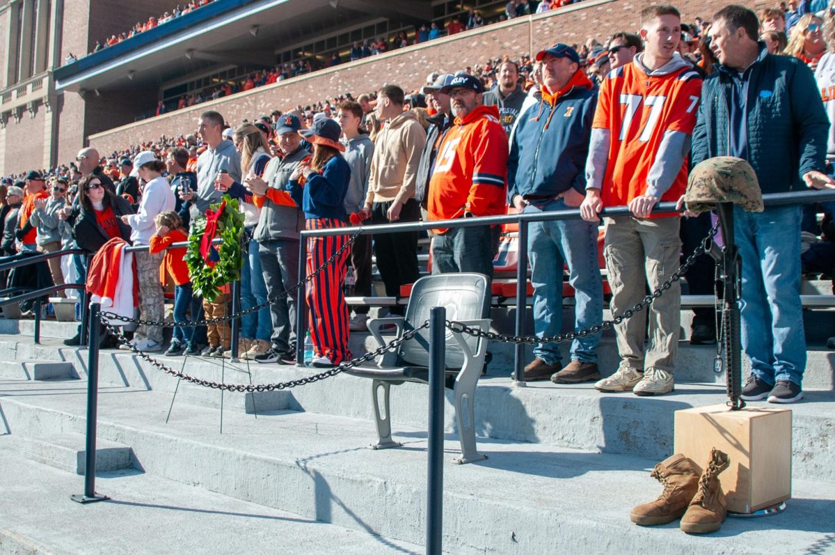 A stadium chair sits empty behind the Illinois home bench in Memorial Stadium to remember POW and MIA soldiers. A member of the UIUC ROTC laid a wreath next to the chair before the start of the game on Saturday, Nov. 2. 