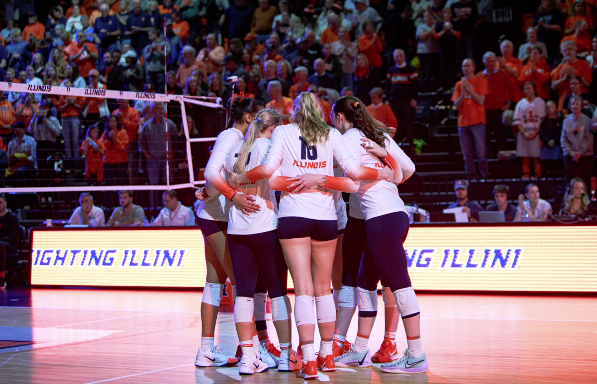 The Illinois volleyball starters take the floor and huddle before first hit on Nov. 7.