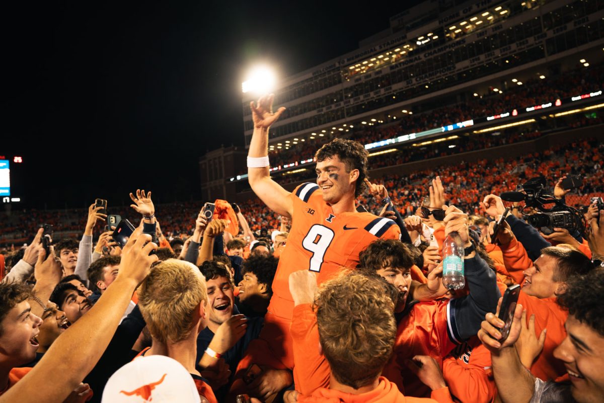 Fans lift up junior quarterback Luke Altmyer in celebration after storming the field to celebrate a 23-17 win over Kansas on Sept. 7.