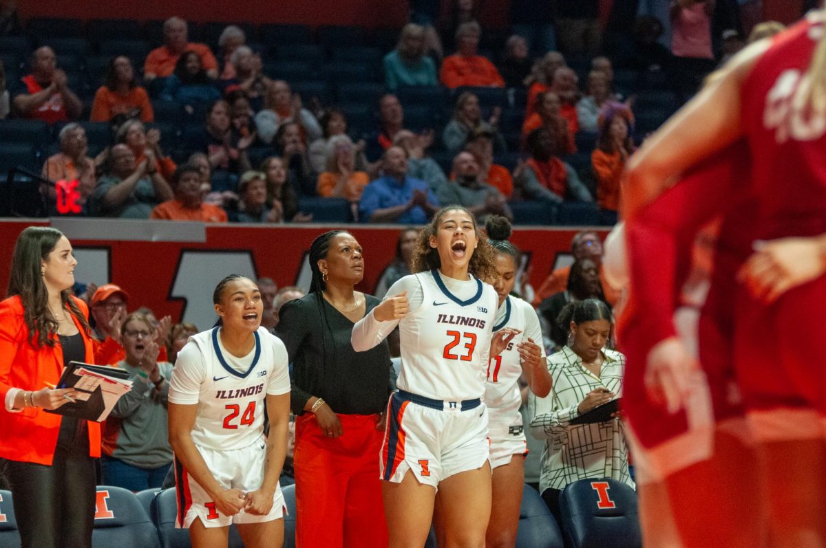 Senior guard Adalia McKenzie and senior forward Brynn Shoup-Hill cheer on the sidelines during Illinois' game against Nebraska on March 3.