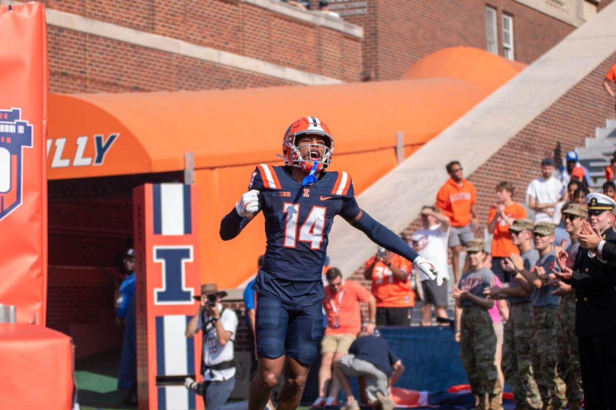 Junior defensive back Xavier Scott runs out of the tunnel before Illinois’ matchup with Purdue at Memorial Stadium on Oct. 12.