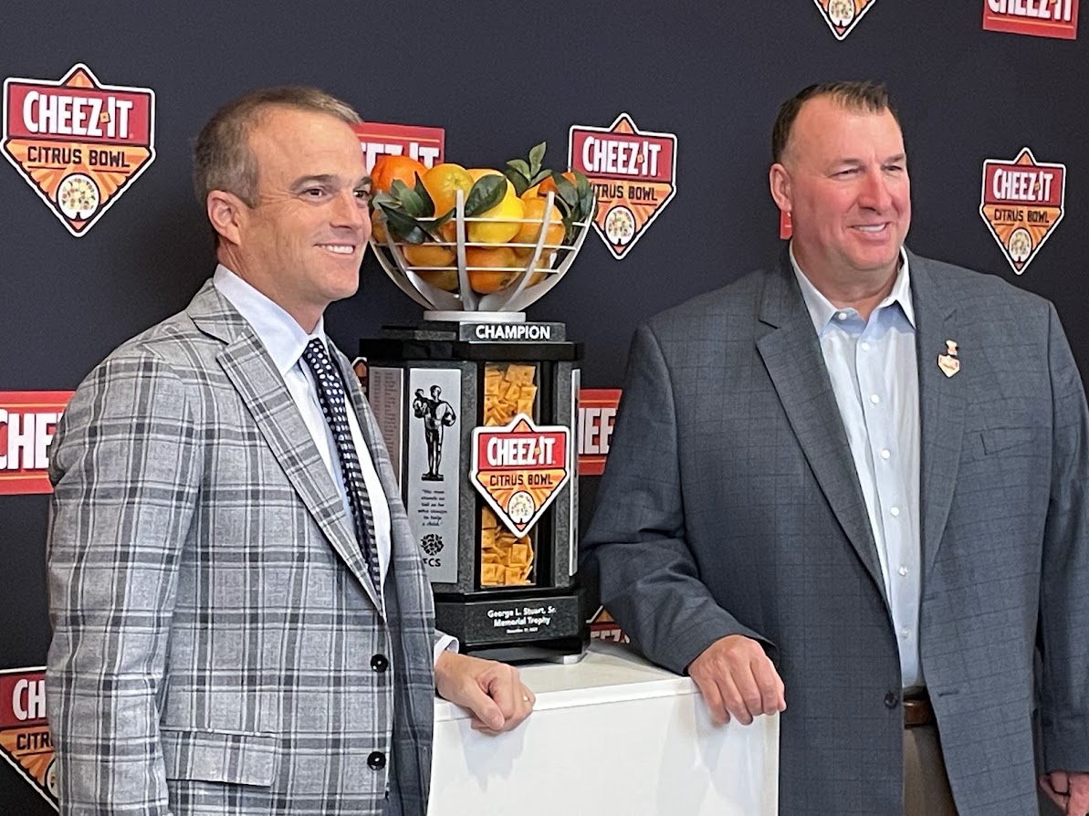 South Carolina coach Shane Beamer and Illinois coach Bret Bielema pose with the Cheez-It Citrus Bowl trophy during an event in Orlando on Sunday. (Matt Murschel/Orlando Sentinel)