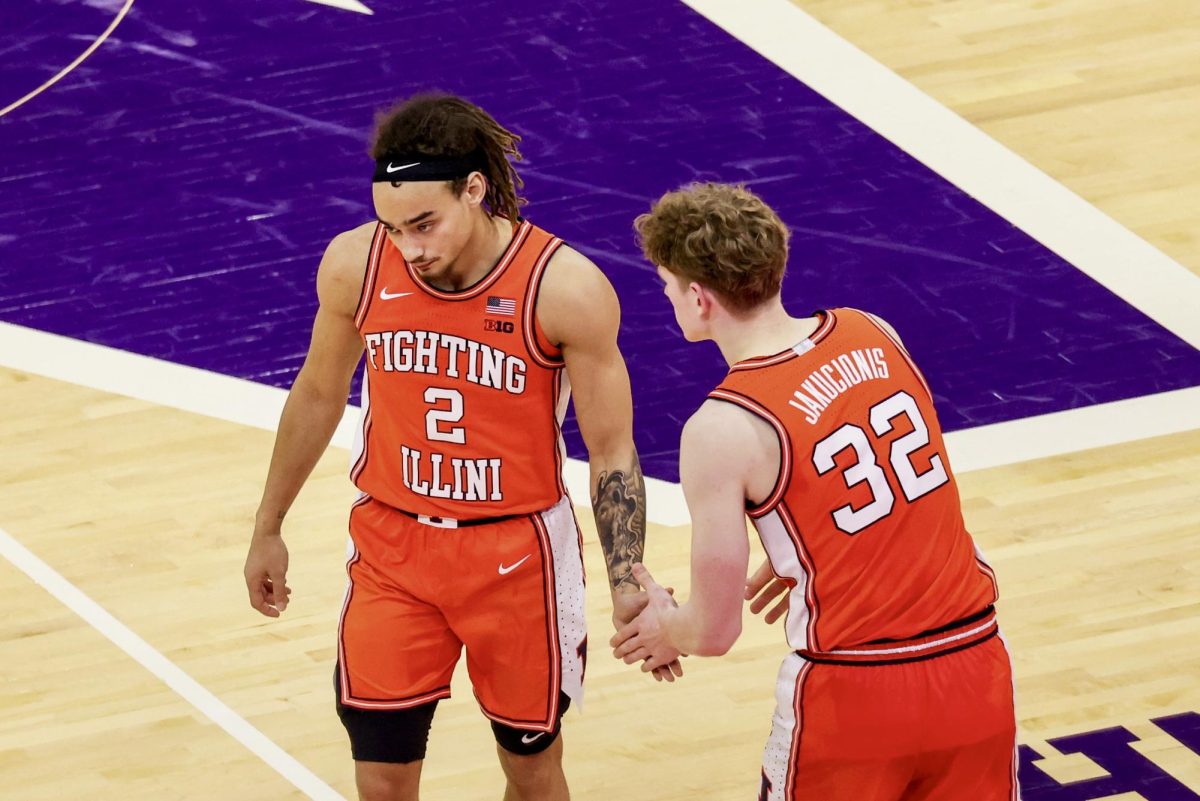 Freshman guard Kasparas Jakucionis checks into the game and talks to sophomore guard Dra Gibbs-Lawhorn at Northwestern on Dec. 6.