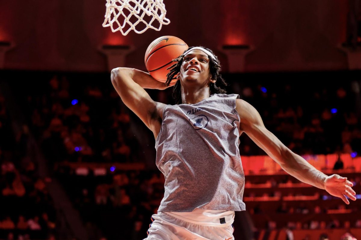 Sophomore forward Carey Booth dunks the ball during pregame warmups on Dec. 10.