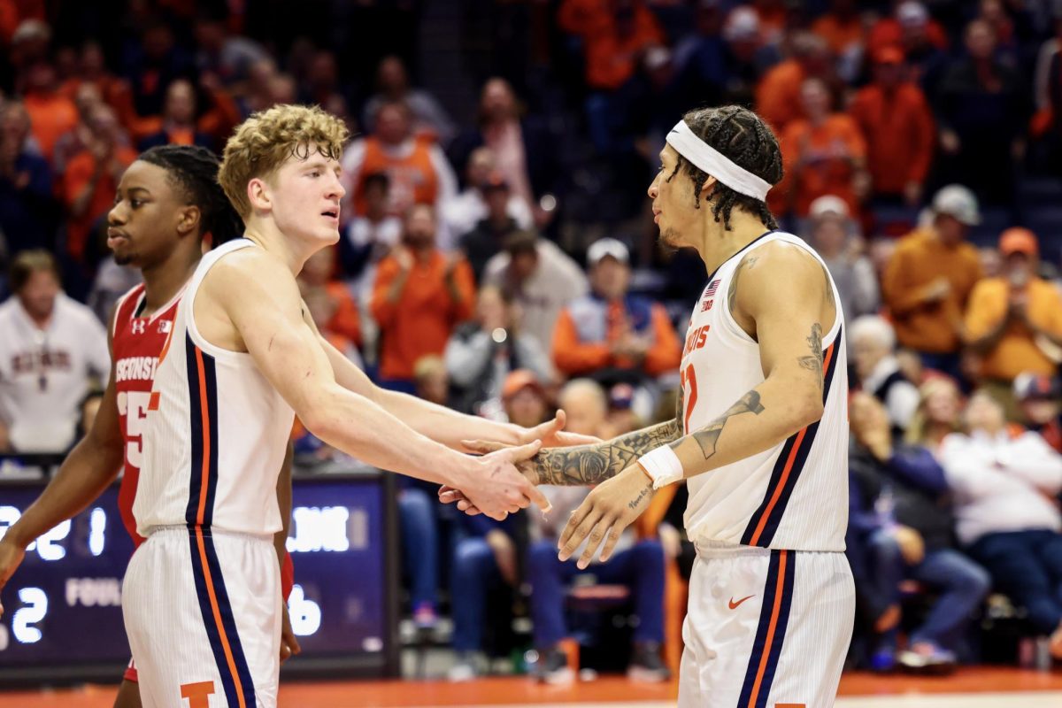 Freshman guard Kasparas Jakucionis and junior guard Tre White celebrate during Illinois’ win over Wisconsin on Dec. 10.