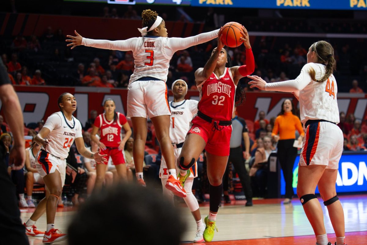 Fifth-year guard Makira Cook jumps on defense against Ohio State on Jan. 24 in State Farm Center.