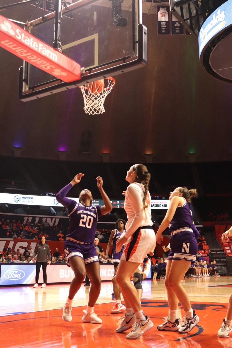 Fifth-year forward Kendall Bostic stands underneath the rim as the basketball goes in the net against Northwestern on Feb. 8.