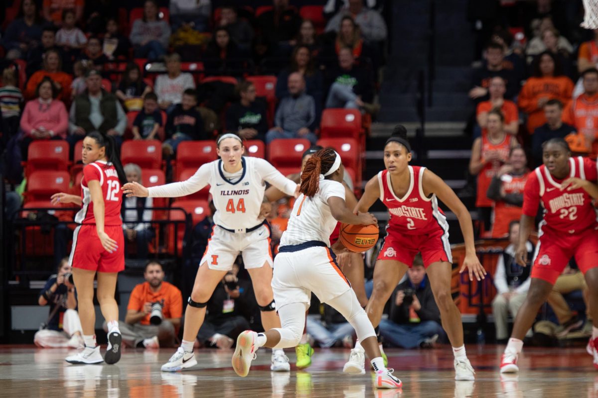 Fifth-year guard Genesis Bryant takes the ball up top as fifth-year forward Kendall Bostic posts up down low on Jan. 25.