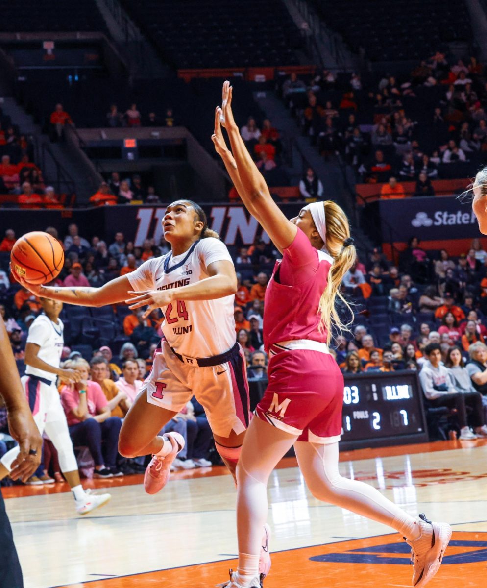 Senior guard Adalia McKenzie fights her way through a Maryland defender to attempt a layup on Feb. 12, 2024.