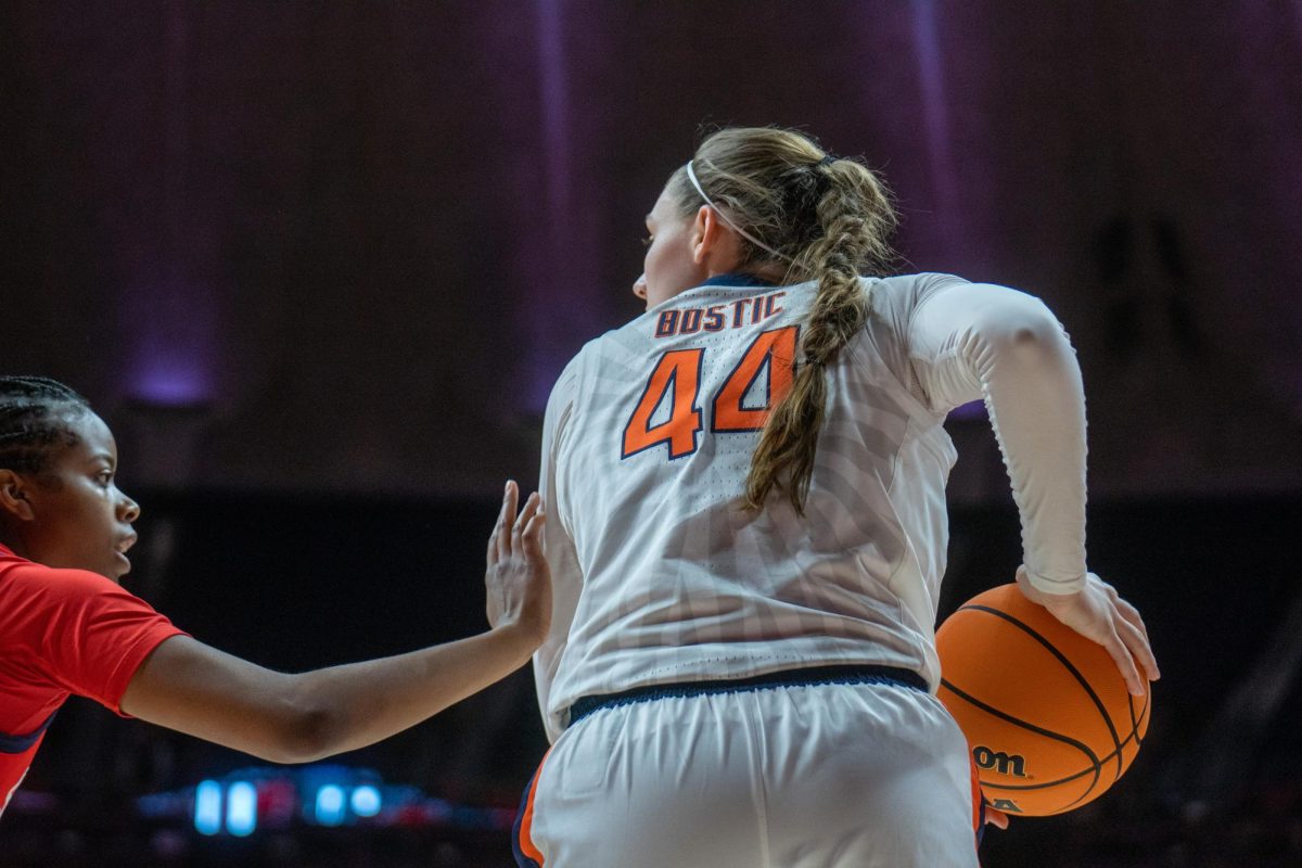 Fifth-year forward Kendall Bostic scans the court for an open Illini on during the game against Stony Brook on March 24, 2024.