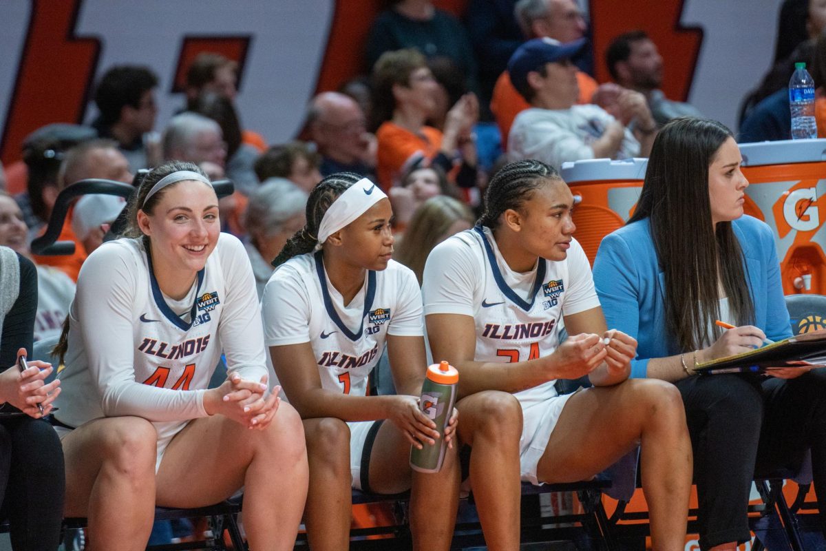 Fifth-year forward Kendall Bostic, fifth-year guard Genesis Bryant and senior guard Adalia McKenzie sit on the bench during a game against Stony Brook on March 24, 2024.