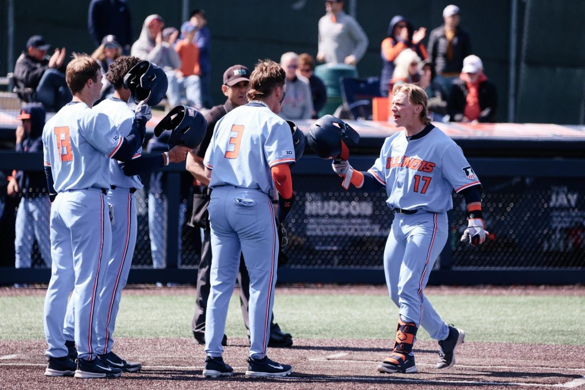 Illinois baseball celebrates after a home run against Northwestern on April 21, 2024.