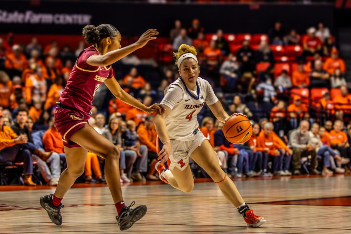 Sophomore guard Gretchen Dolan attempts to drive the ball past her Florida State opponent on Nov. 7, 2024, at State Farm Center.