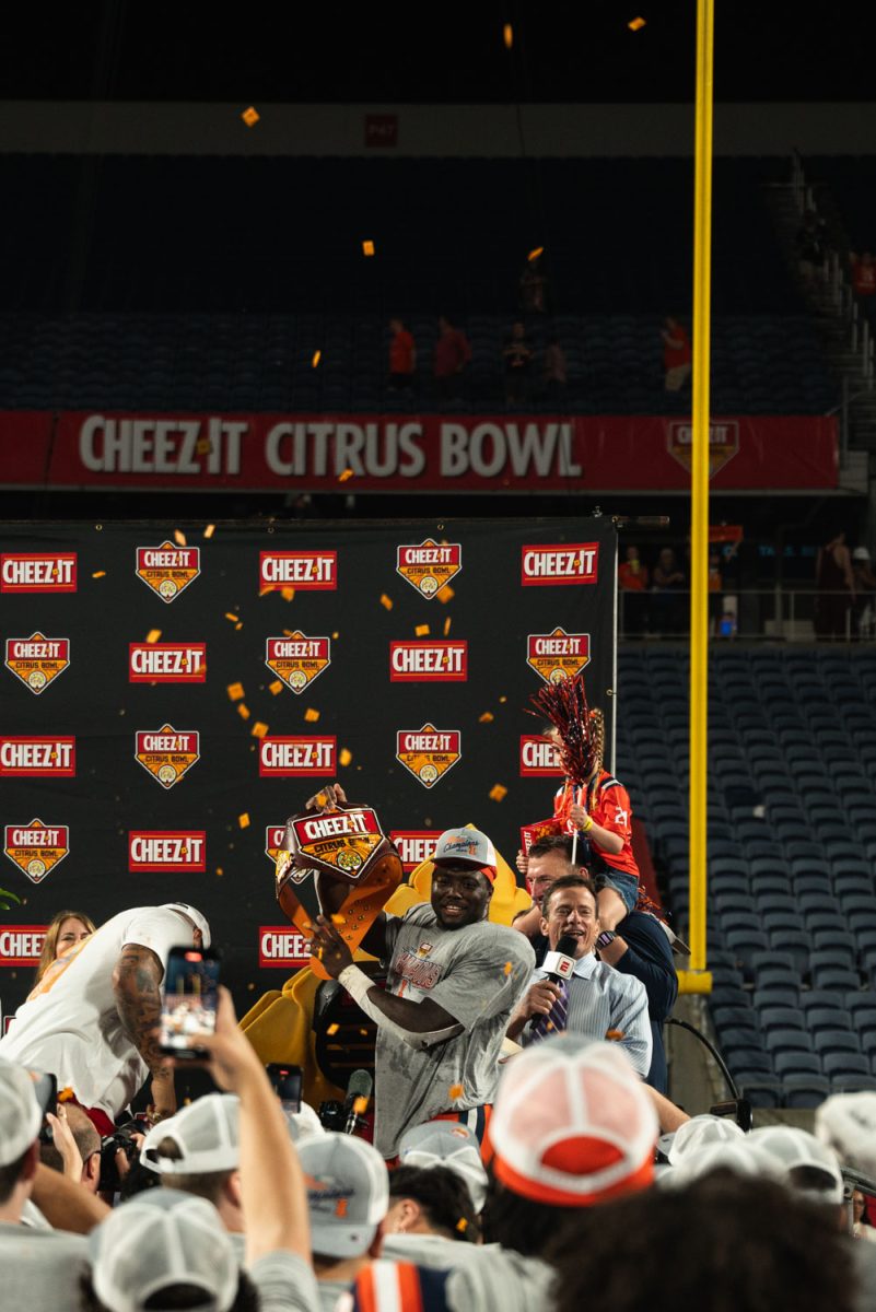 Junior running back Josh McCray presents the Cheez-It championship belt to his teammates.