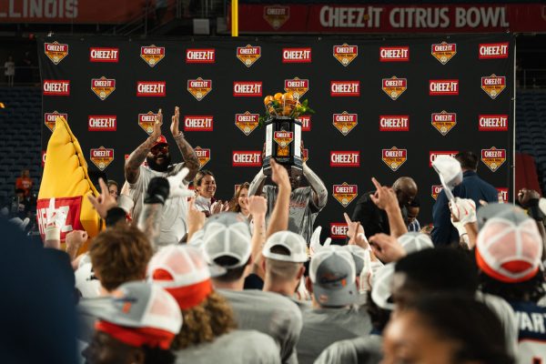 Junior running back Josh McCray lifts the Cheez-It Citrus Bowl trophy in the air after Illinois stood victorious over South Carolina, 21-17.