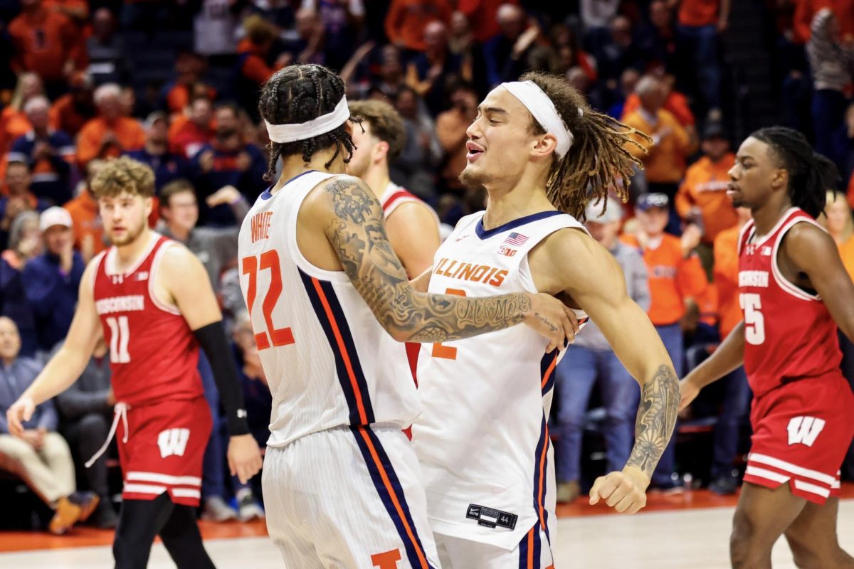 Junior guard Tre White (left) and sophomore guard Dra Gibbs-Lawhorn (right) chest bump during a game against Wisconsin on Dec. 10, 2024.