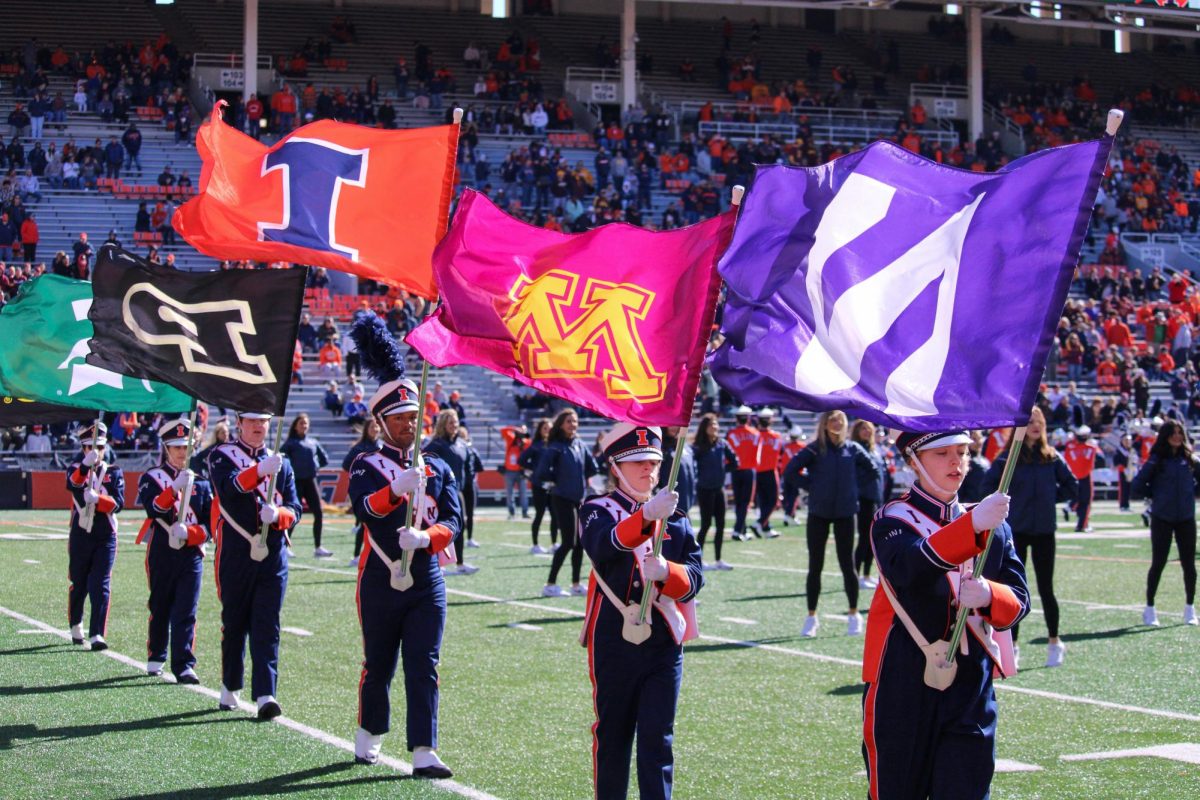 The Marching Illini hold the Big Ten flags high in a pregame performance on Oct. 15, 2022. 