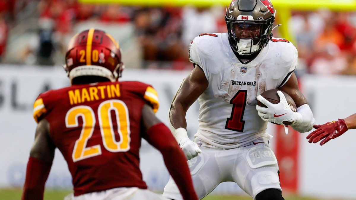 Tampa Bay Buccaneers running back Rachaad White (1) carries the ball while being defended by Commanders safety Quan Martin (20) during the fourth quarter on Sept. 8, 2024. (Jefferee Woo/Tampa Bay Times/TNS)