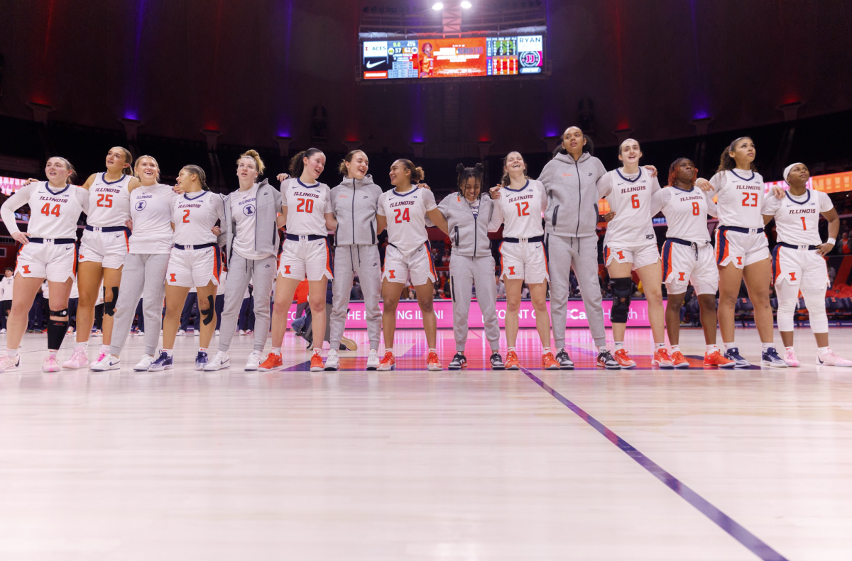 The Illini celebrate a win over No. 23 Iowa by embracing each other during Hail to the Orange on Jan. 9. 