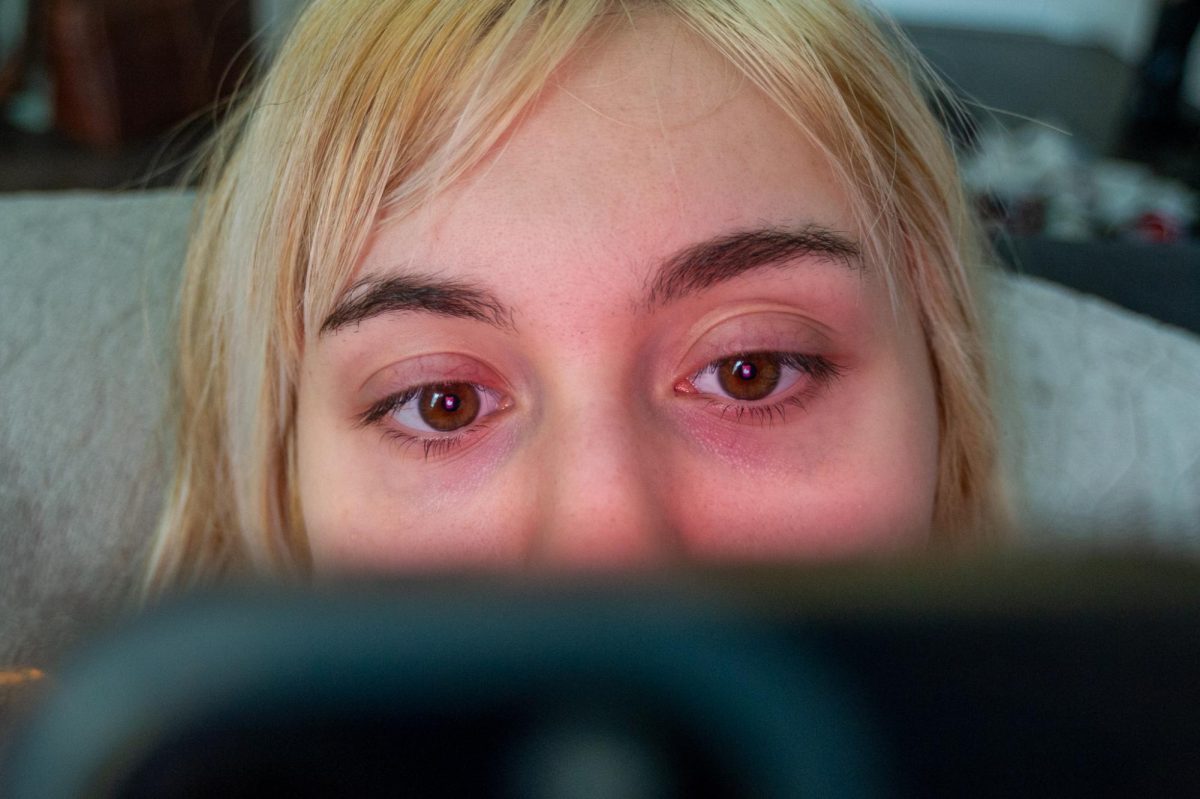 A student scrolls on Tinder, a massive platform for online dating.