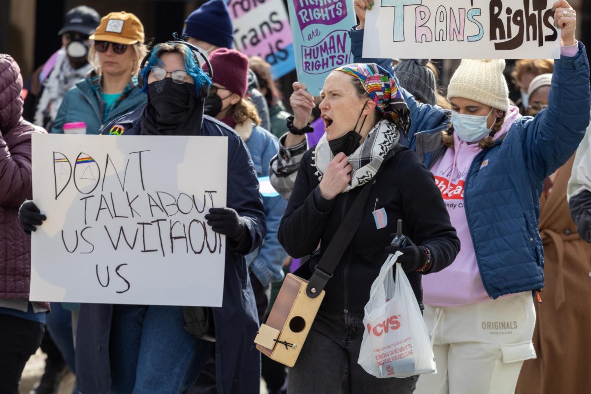 Protesters march through the streets of downtown Champaign on Saturday, advocating for transgender rights.