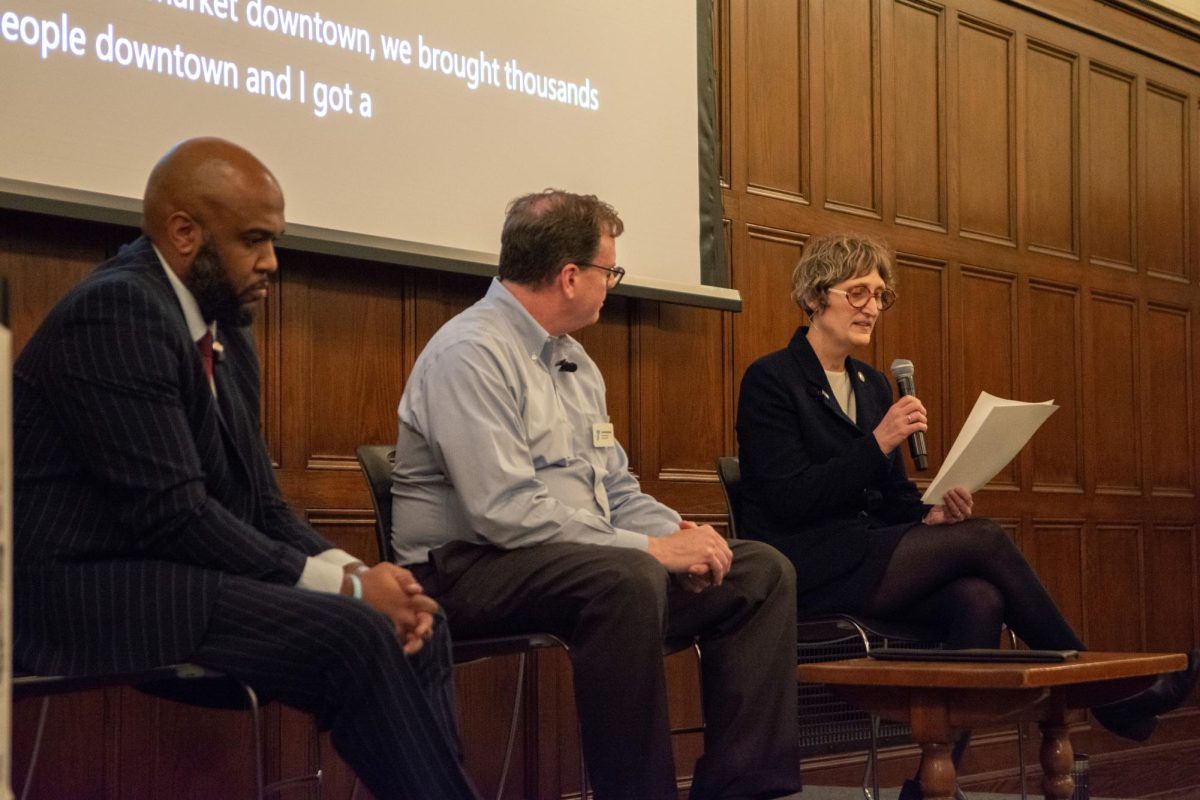 Urbana mayoral candidates Deshawn Williams (left) and Annie Adams (right) introduce themselves at the beginning of a forum at the University YMCA on Wednesday night. The two candidates have been appearing in front of the community often ahead of the February 25th vote.