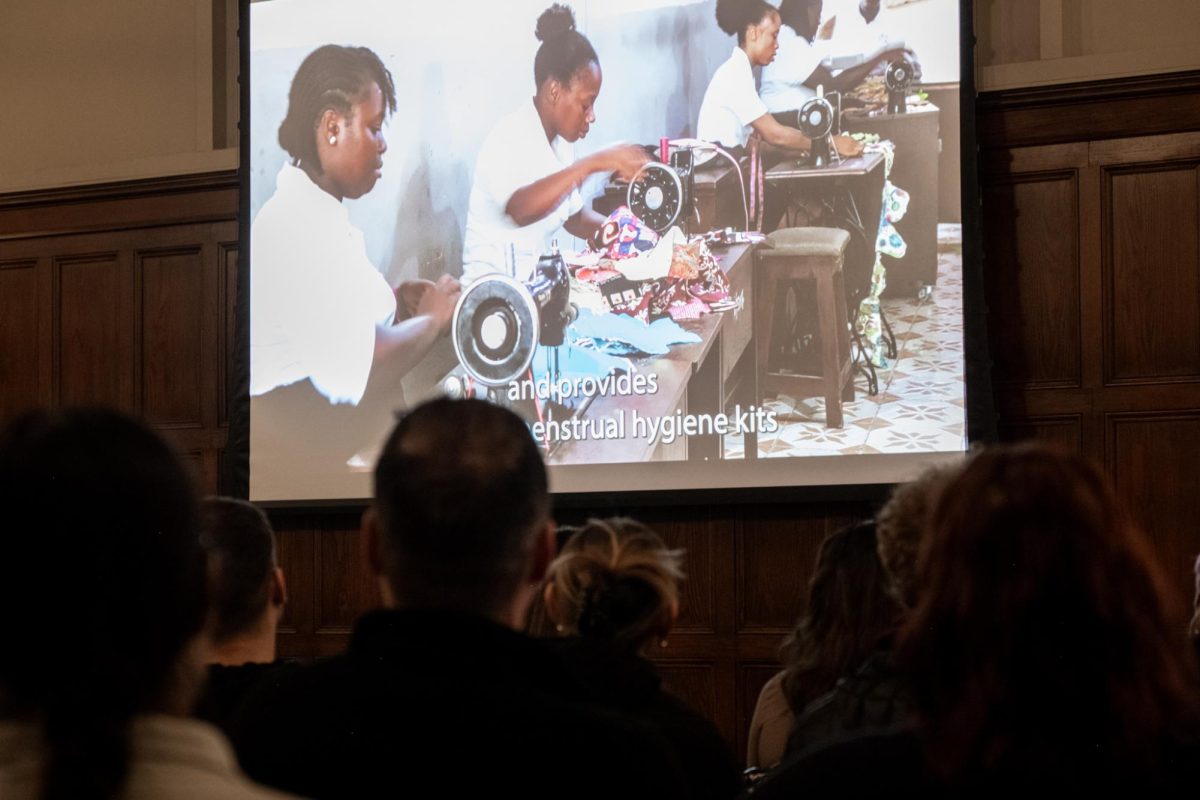 Audience members at the Uman Tok discussion on Feb. 13 watch a preview of the forthcoming film, “The Woman of Uman Tok Reframe Menstruation in Sierra Leone.” 