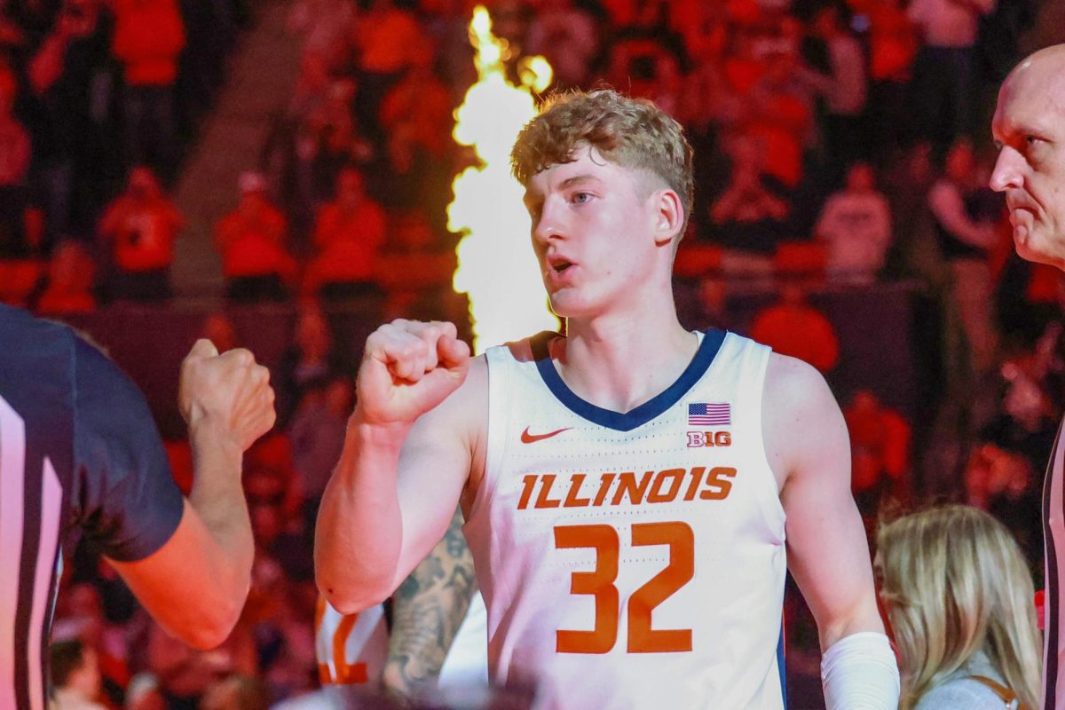 Freshman guard Kasparas Jakučionis fist bumps the referees as the starting lineups are announced ahead of Illinois' Feb. 2 matchup against Ohio State.
