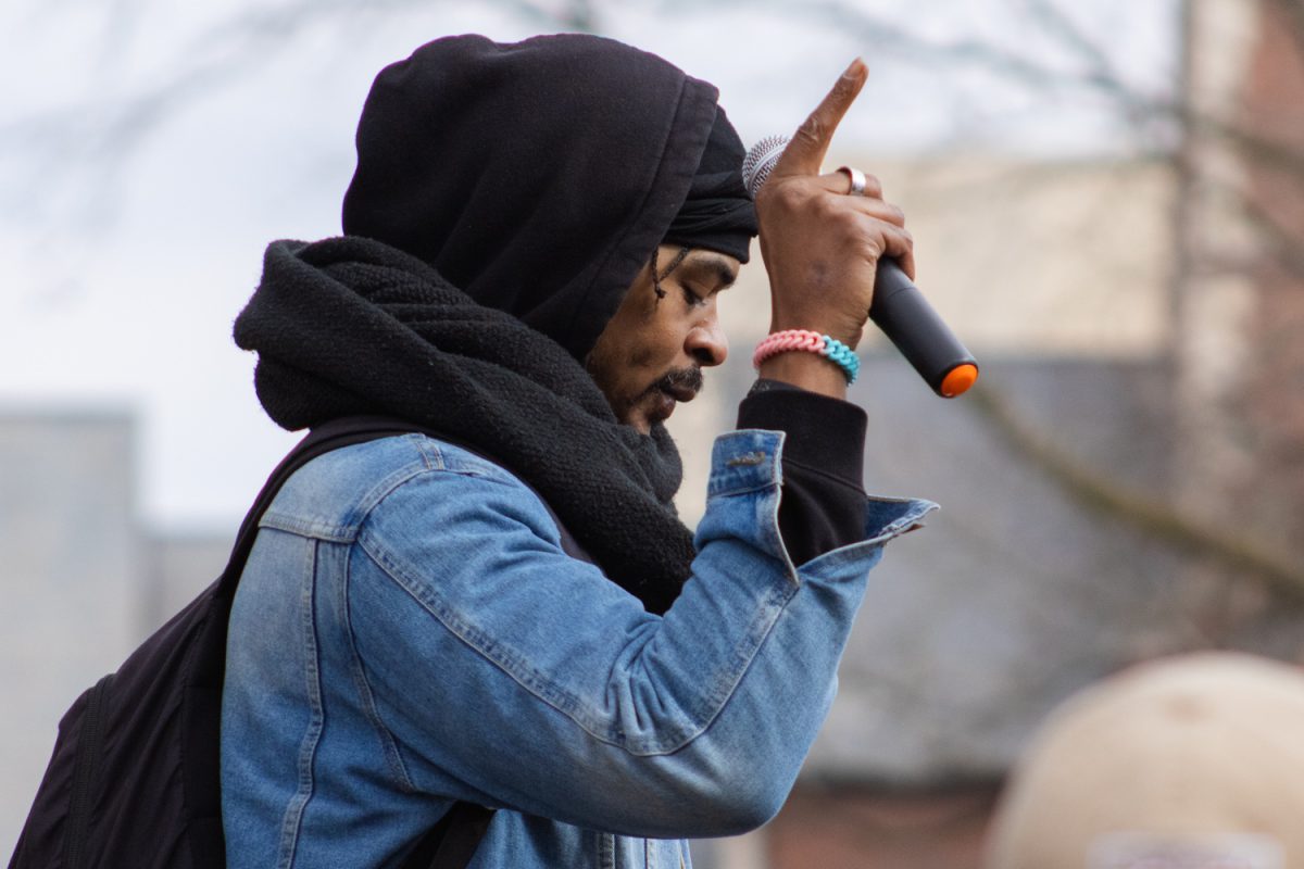 Justin Michael Hendrix speaks at protest for transgender rights in downtown Champaign on Saturday. Hendrix is the founder of community organization HITNHOMEBOY, which focuses on providing resources to marginalized communities in Champaign-Urbana.
