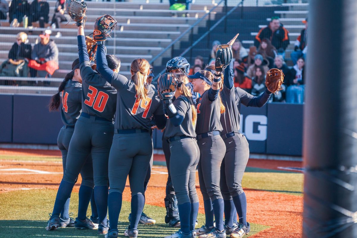 Illinois softball meets in a team huddle during a game against SIUE on March 27, 2024.