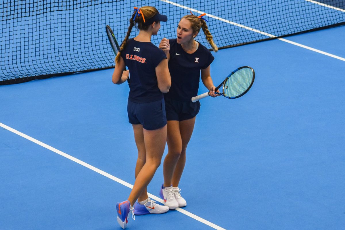 Junior McKenna Schaefbauer (left) and senior Kasia Treiber (right) celebrate during a doubles match against Northwestern. The Illini defeated the Wildcats 4-2 on Jan. 26.