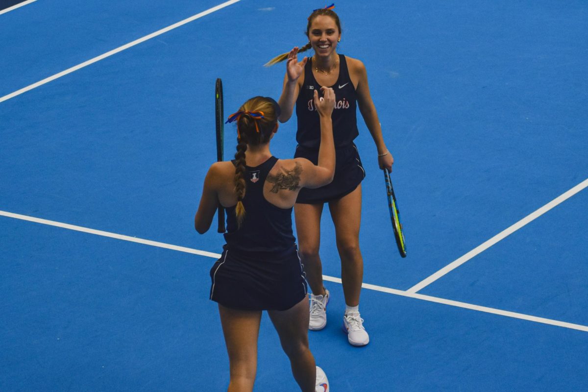 Senior McKenna Schaefbauer (left) and senior Kasia Treiber celebrate during a doubles match against Oklahoma State on Feb. 8.