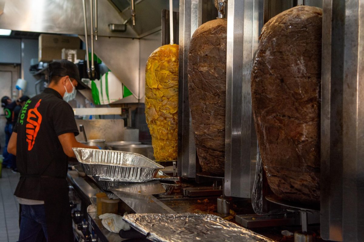 A Shawarma Joint staff employee prepares the meat in the kitchen for customers to enjoy on Feb. 10.