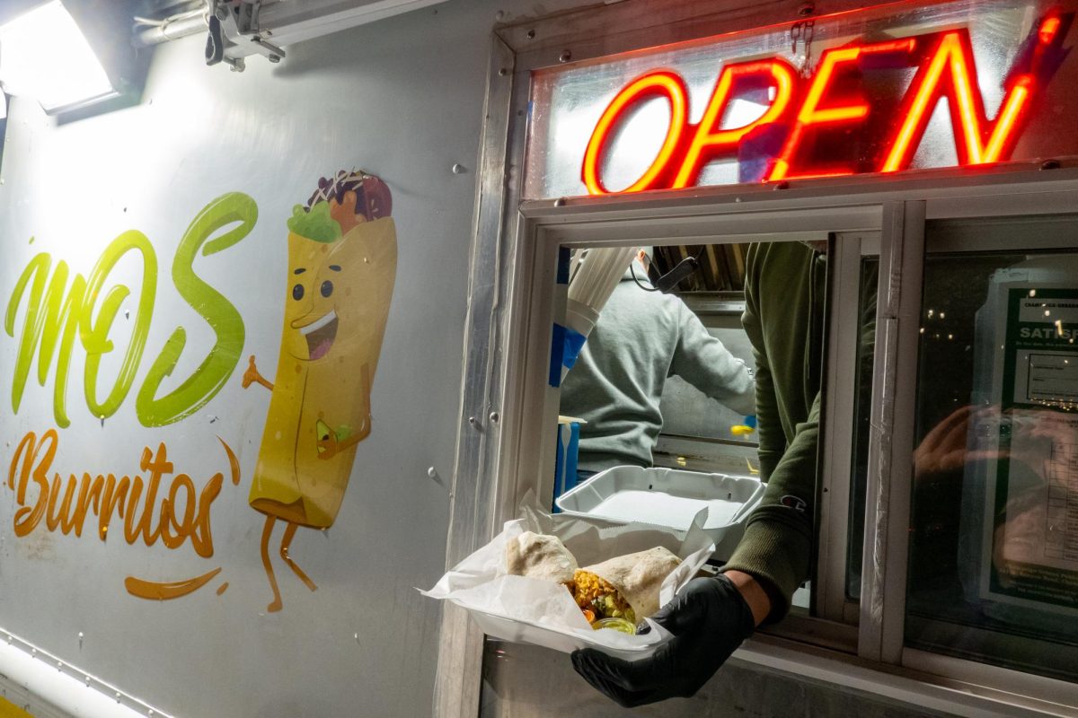 Mo's Burritos food truck vendor Fernandez serves up their signature burrito dish. Mo's Burritos often settles just outside Joe's Brewery on South 5th Street in the evenings.