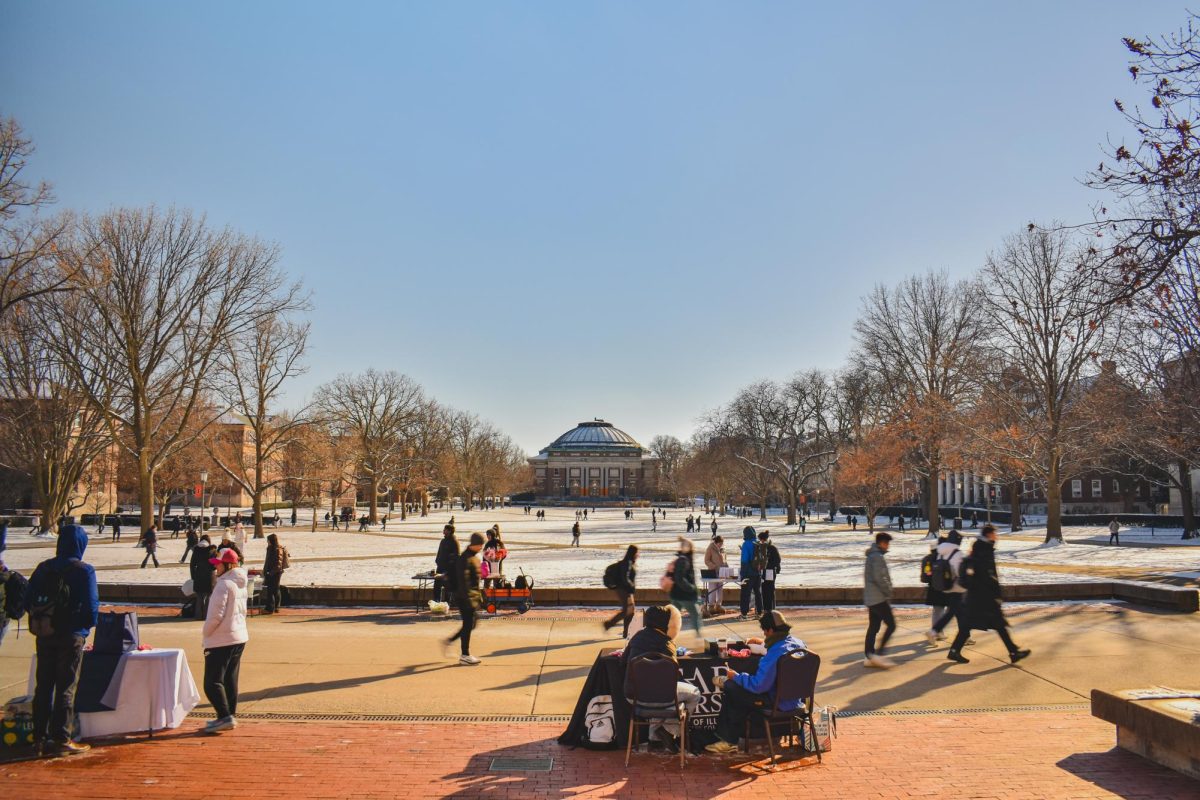 Student groups table in Anniversary Plaza at the top of the Main Quad as bustling student traffic moves past on Feb. 15.