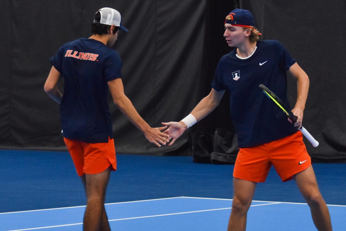 Redshirt sophomore Tyler Bowers high-fives redshirt freshman Zach Viiala during a match against Clemson on Feb. 15. 
