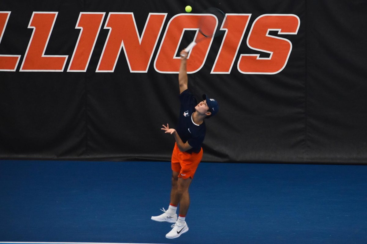 Junior Jeremy Zhang leaps up to serve during a match against Clemson on Feb. 15. 