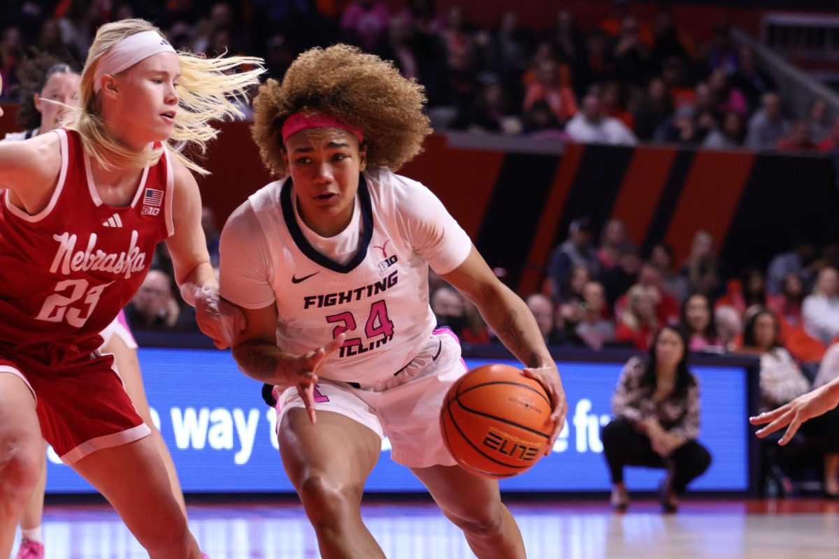 Senior guard Adalia McKenzie dribbles next to freshman guard Britt Prince in a game against Nebraska on Feb. 16. 