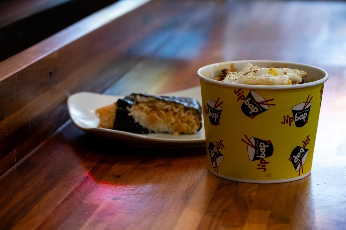 A meal from Jim Bap alongside a side dish rests on a table on Feb. 19.