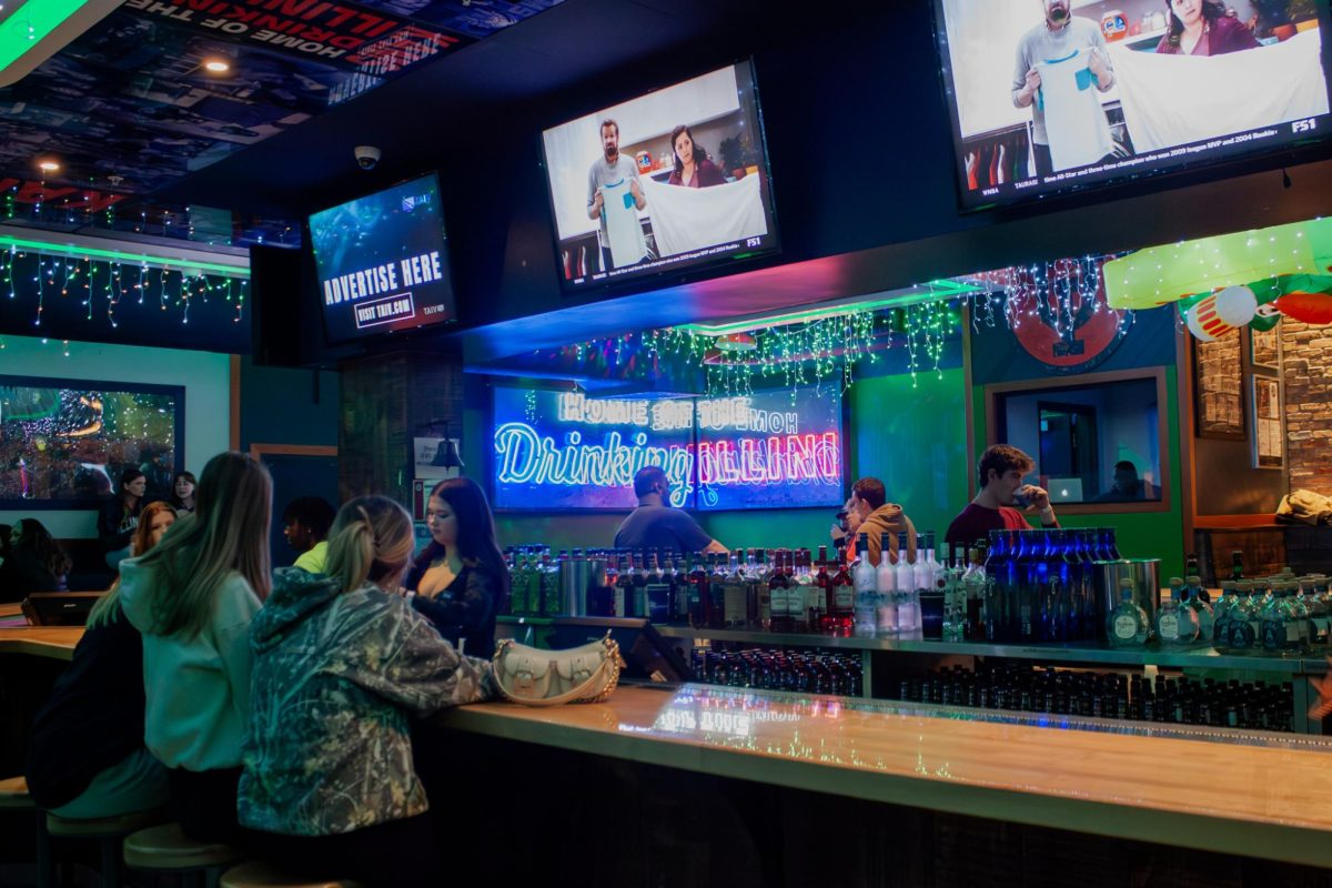 KAMS staff prepares for customers as people fill the bar for Time Warp Tuesday on Feb. 25.