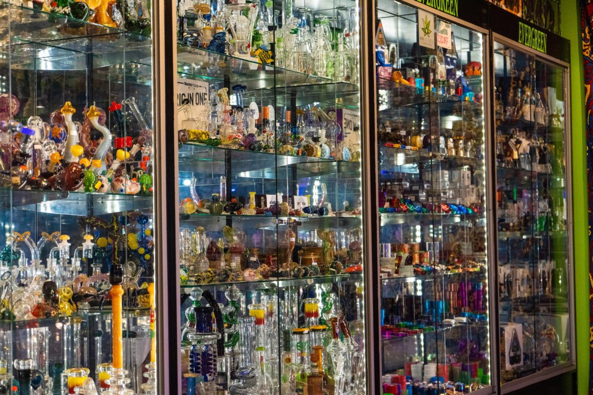 One of the many glass cabinets at Evergreen Tobacco & Smoke is filled with colorful bongs, pipes, grinder and more on Feb. 28.