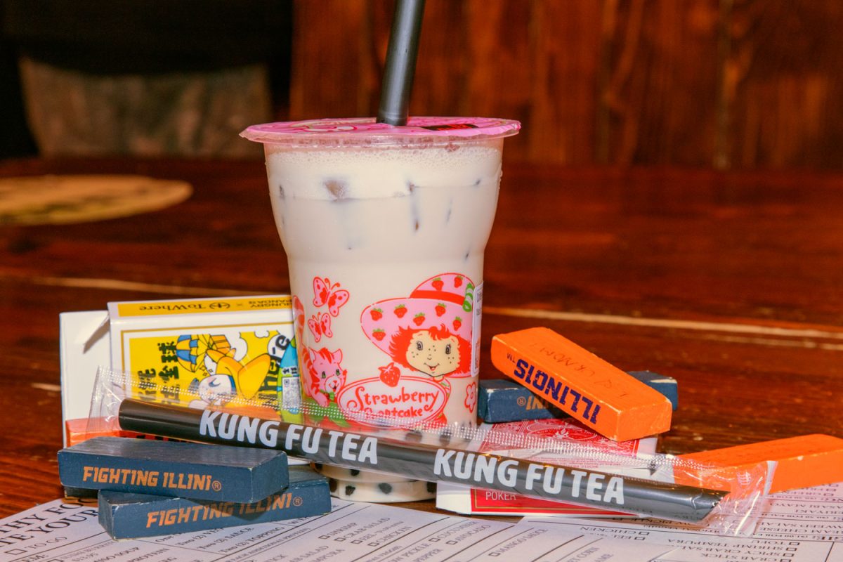 Kung Fu Tea's coffee milk tea with bubbles amidst the several games available at the boba shop on Feb. 27th. The cup is decorated to promote their Strawberry Shortcake drink promotion, one of the many promotions, of fun themed drinks Kung Fu Tea offers.