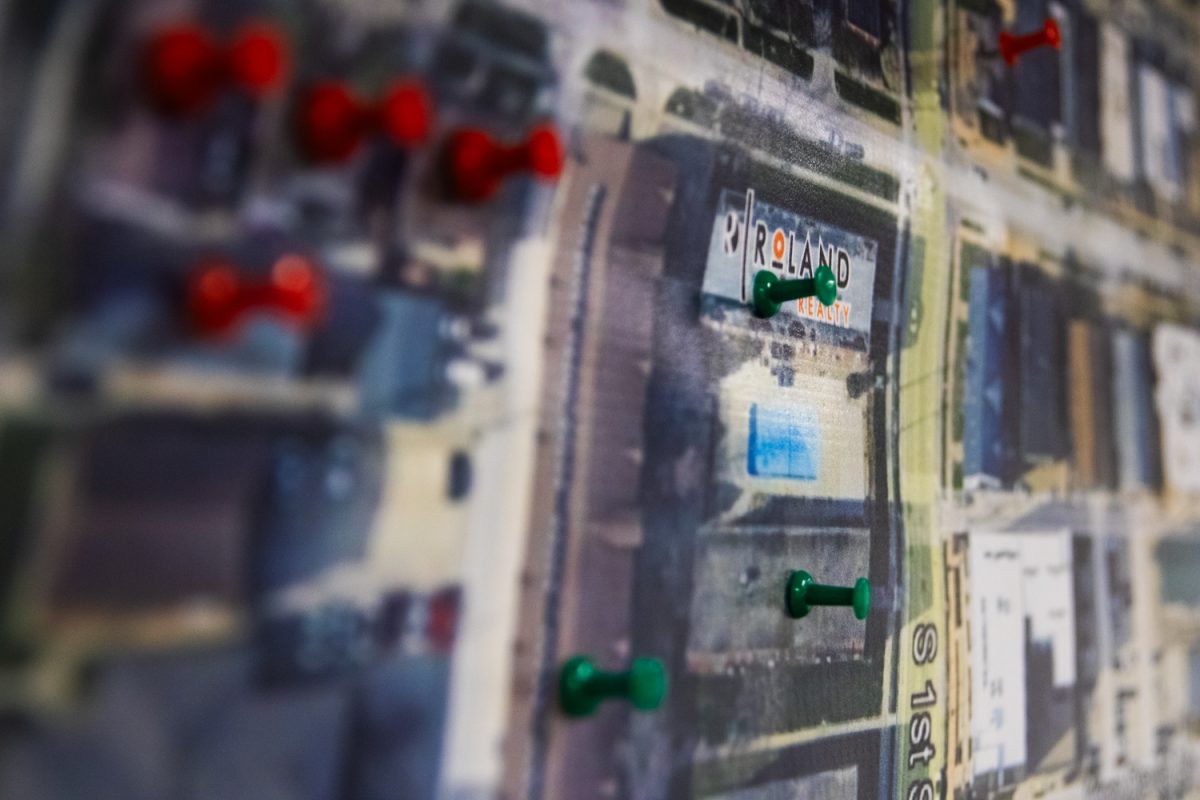 A map marking Roland Realty's properties with pins hangs on the wall in a Roland office on Friday, Feb. 28.