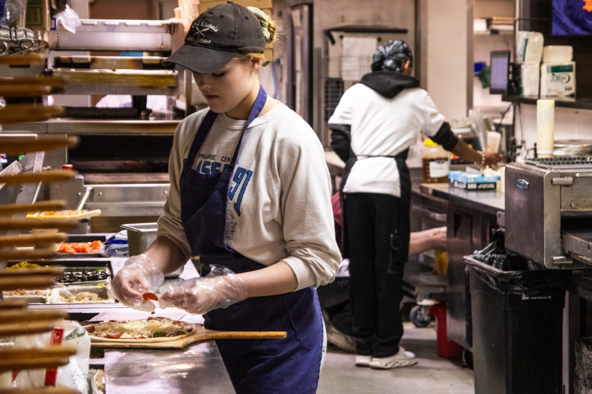 Mia Za's employees on E Green St. prepare food and speak with customers on Mar. 1.