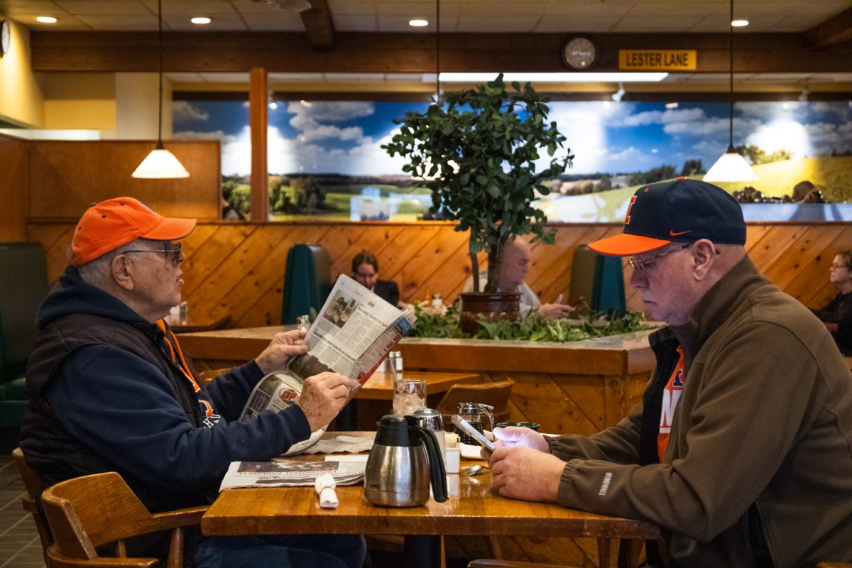 Customers look through The Original Pancake House's menu on the morning of March 3.