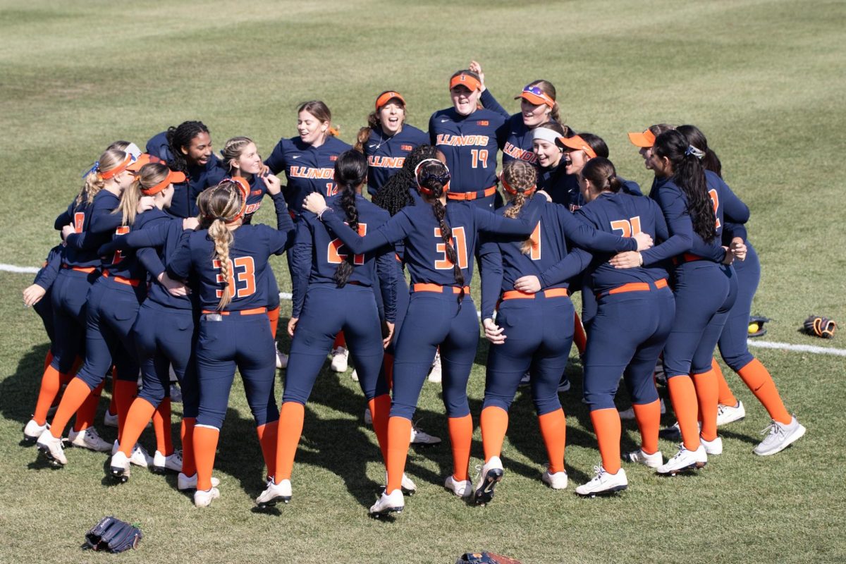 Illinois softball in a circle before a game against Saint Louis on March 3. 
