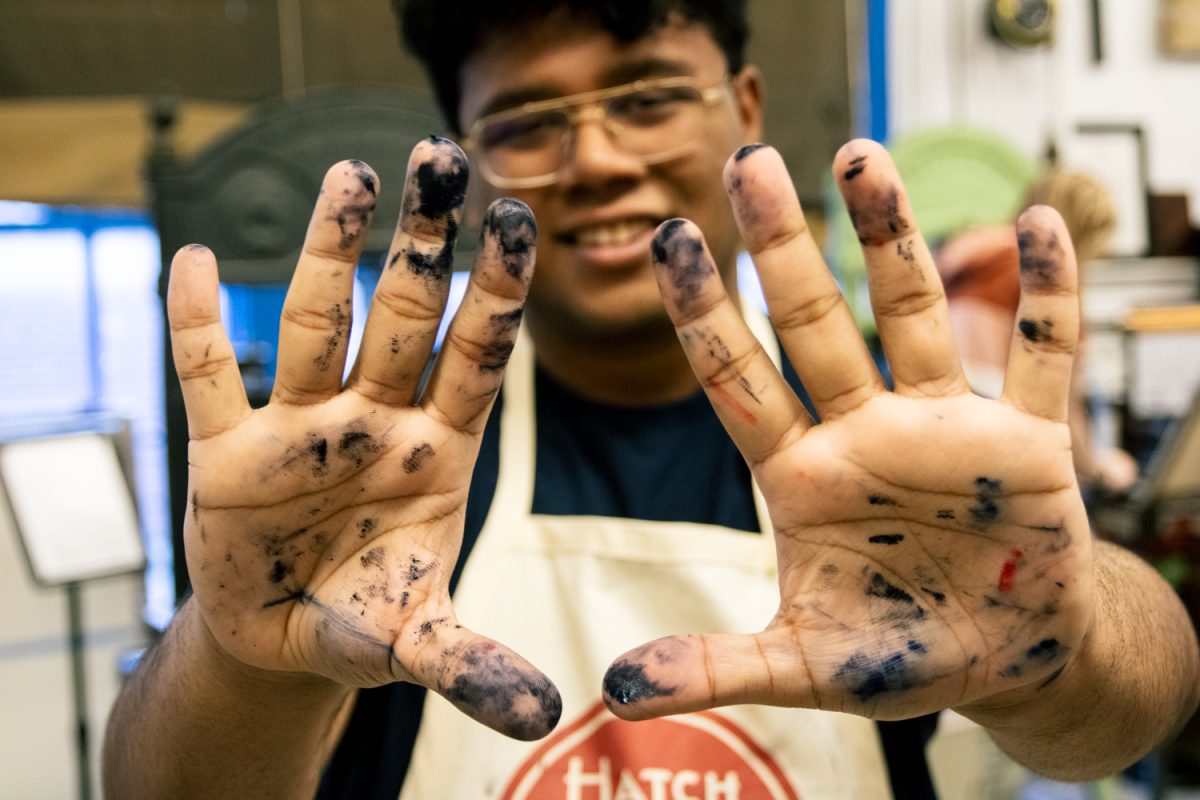 Skeuomorphics club president Aaron Mukhopadhyay, a senior in LAS, shows off his inky hands after using the Skeuomorph Press on March 6. The club holds meetings at the Skeumorph Press in the Champaign-Urbana Community Fab Lab.