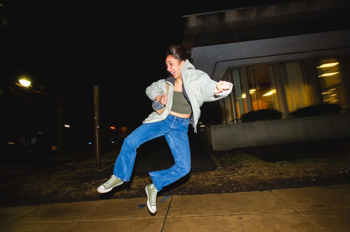Olivia Al-Shayeb, junior in Social Work, dances on her way to a party on Friday of Unofficial weekend.