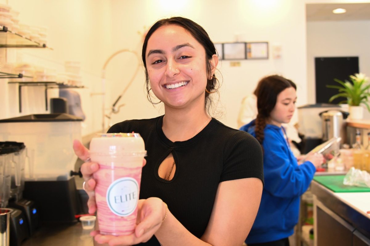 Vidhi Chavda, sophomore in Engineering, holds a drink she made in her store, “Elite,” on April 6. 